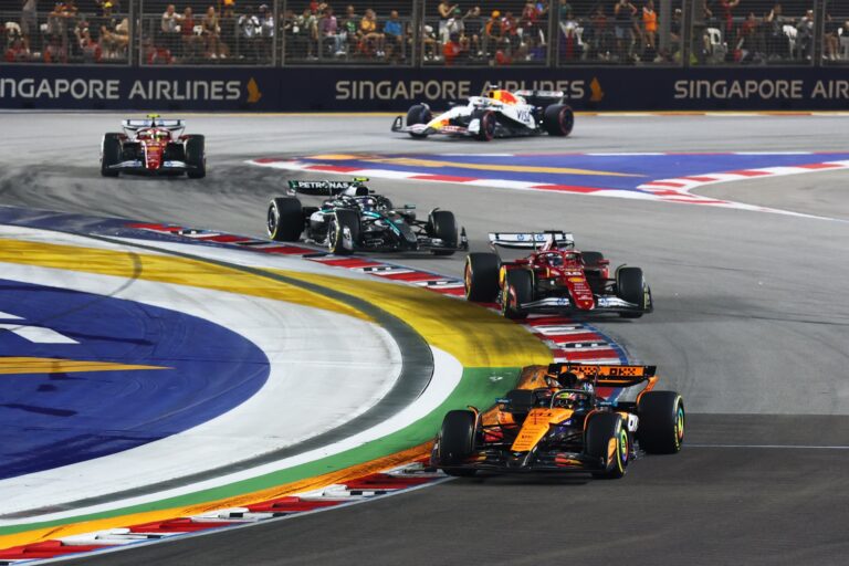 SINGAPORE, SINGAPORE - OCTOBER 05: Oscar Piastri of Australia driving the (81) McLaren MCL39 Mercedes leads Charles Leclerc of Monaco driving the (16) Scuderia Ferrari SF-25 on track prior to the F1 Grand Prix of Singapore at Marina Bay Street Circuit on October 05, 2025 in Singapore, Singapore. (Photo by Mark Thompson/Getty Images)